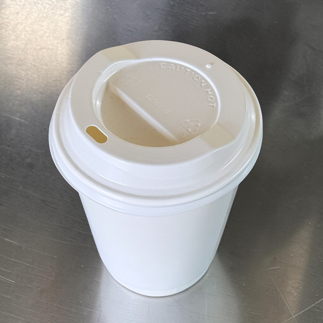 White Double Wall 12oz Paper Cup With White Sip Lids Overhead - Propus Packaging
