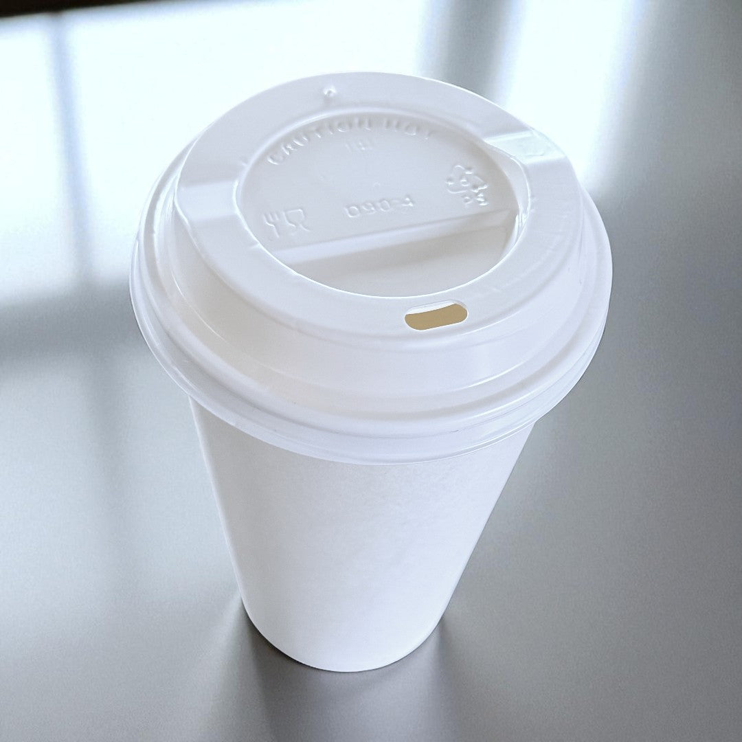 White Single Wall 16oz Paper Cup With White Sip Lids Overhead - Propus Packaging